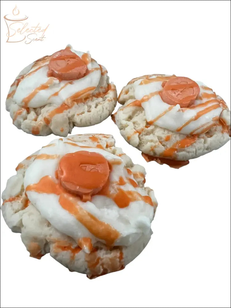 Selected Scent vanilla pumpkin spice wax melts shaped like frosted cookie rounds with orange drizzle