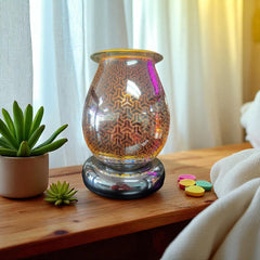 Selected Scent Electric Decorative Warmer with geometric pattern on a wooden surface next to small plants and colorful wax melts