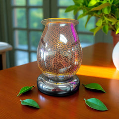 Selected Scent Electric Decorative Warmer with geometric glass design on wooden table with green leaves